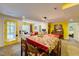 Open basement with a table, piano, sitting area, and yellow door to the exterior at 6 Chelan Ct, Durham, NC 27713