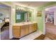 Spacious bathroom with dual sinks, bright lighting, and serene green walls for a refreshing experience at 6 Chelan Ct, Durham, NC 27713