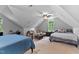 Spacious bedroom featuring two beds, a cozy seating area, and natural light from a arched window at 6 Chelan Ct, Durham, NC 27713