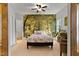 Beautiful bedroom featuring a large mural of a forest, neutral colored walls and carpet, and cozy decor at 6 Chelan Ct, Durham, NC 27713