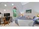 Cozy bedroom featuring a window with stained glass, a desk, and calm colored walls and carpet at 6 Chelan Ct, Durham, NC 27713