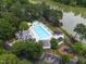 An aerial view showcases the community pool and play area near a tranquil lake at 6 Chelan Ct, Durham, NC 27713