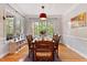Bright dining room with hardwood floors, a large window, and a wooden dining table with six chairs at 6 Chelan Ct, Durham, NC 27713