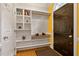 Foyer featuring hardwood floors, a decorative shelving unit, and a dark-colored front door with a storm door at 6 Chelan Ct, Durham, NC 27713