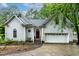 Charming two-story home with a red front door, white trim, an attached garage, and well-maintained landscaping at 6 Chelan Ct, Durham, NC 27713