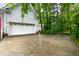Exterior shot of a two-car garage with a concrete driveway and mature trees in the background at 6 Chelan Ct, Durham, NC 27713
