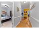 Inviting hallway with hardwood floors leading to a bedroom and living spaces with bright, colorful walls at 6 Chelan Ct, Durham, NC 27713
