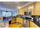 Kitchen with stainless steel appliances, dark countertops, and an adjacent dining area at 6 Chelan Ct, Durham, NC 27713