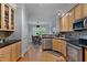 Bright kitchen with wood cabinets, stainless steel appliances and an open layout to the dining area at 6 Chelan Ct, Durham, NC 27713