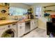Basement kitchenette includes small appliances, shelving, and a laundry unit at 6 Chelan Ct, Durham, NC 27713