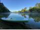 The glassy lake is pictured on a misty morning from ground level with a paddleboard nearby at 6 Chelan Ct, Durham, NC 27713