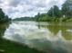 The lake is pictured on a cloudy day from ground level with green grass nearby at 6 Chelan Ct, Durham, NC 27713