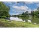 Scenic lake view with a bench and lush greenery at 6 Chelan Ct, Durham, NC 27713