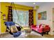 Inviting living room with hanging chair, bright yellow walls and red sofa, perfect for relaxing and entertaining guests at 6 Chelan Ct, Durham, NC 27713