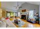 Bright living room with high ceilings, fireplace, and sliding barn doors to the primary bedroom at 6 Chelan Ct, Durham, NC 27713