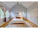Main bedroom with vaulted ceiling, large windows, and a neutral color palette at 6 Chelan Ct, Durham, NC 27713