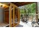 Enclosed porch with wooden sauna, exercise bike and wooded backyard views at 6 Chelan Ct, Durham, NC 27713