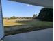 A back porch with scenic views of a field, trees, and clear blue skies at 600 Sweet Potato Lane # 38, Nashville, NC 27856