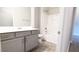 Well-lit bathroom with a vanity, tiled floor, and combination shower and tub at 600 Sweet Potato Lane # 38, Nashville, NC 27856
