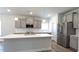 Bright kitchen with gray cabinets, stainless steel appliances, and a spacious island with quartz countertops at 600 Sweet Potato Lane # 38, Nashville, NC 27856