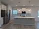 Modern kitchen featuring a large island, stainless appliances, and quartz countertops at 600 Sweet Potato Lane # 38, Nashville, NC 27856