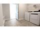 Light filled laundry room featuring modern washer and dryer and overhead wire shelf at 600 Sweet Potato Lane # 38, Nashville, NC 27856