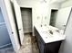 Stylish bathroom featuring dual sinks, modern fixtures, and access to a linen closet at 606 Melrose Ct, Sanford, NC 27330
