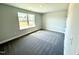 Bright bedroom featuring a window offering a view and neutral carpet at 606 Melrose Ct, Sanford, NC 27330