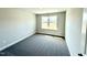 This bedroom offers natural light through its window and neutral colored carpet at 606 Melrose Ct, Sanford, NC 27330