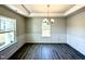 Elegant dining room with chair rail molding, tray ceiling, and stylish light fixture at 606 Melrose Ct, Sanford, NC 27330