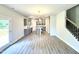 Open-concept kitchen featuring modern appliances, kitchen island, and easy access to the staircase at 606 Melrose Ct, Sanford, NC 27330