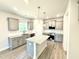 Modern kitchen features gray cabinets, granite countertops, and stainless steel appliances at 606 Melrose Ct, Sanford, NC 27330