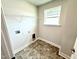 Well-lit laundry room with a window, hookups, and ample shelving for convenient storage at 606 Melrose Ct, Sanford, NC 27330