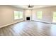 Bright living room featuring a fireplace and laminate flooring with views of the outdoors at 606 Melrose Ct, Sanford, NC 27330