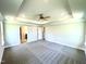 Large main bedroom with carpet, tray ceiling, and access to en-suite bathroom at 606 Melrose Ct, Sanford, NC 27330