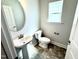 Contemporary powder room includes pedestal sink, modern faucet, and natural light at 606 Melrose Ct, Sanford, NC 27330