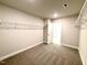 Walk-in closet with carpet, wire shelving, and a door at 606 Melrose Ct, Sanford, NC 27330