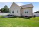 Backyard showcasing the lawn and the exterior of the home, surrounded by a white vinyl fence at 608 W Godwin St, Dunn, NC 28334