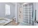 Well-lit bathroom with a bathtub and shower, and a granite countertop sink at 608 W Godwin St, Dunn, NC 28334