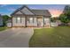 Charming single-story home boasts a manicured lawn, a concrete driveway, and classic curb appeal at 608 W Godwin St, Dunn, NC 28334