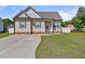 Charming single-story home boasts a manicured lawn, a concrete driveway, and classic curb appeal at 608 W Godwin St, Dunn, NC 28334