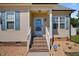 Inviting front porch with brick steps and white railings, a charming entry to welcome you home at 608 W Godwin St, Dunn, NC 28334