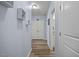 Hallway with white trim, wood floor, closet and art decorations at 608 W Godwin St, Dunn, NC 28334
