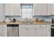 Bright kitchen featuring stainless steel appliances, granite countertops, and wood-look flooring at 608 W Godwin St, Dunn, NC 28334
