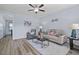 Cozy living room with wood flooring, ceiling fan, and neutral paint, perfect for relaxing or entertaining at 608 W Godwin St, Dunn, NC 28334