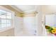 Bright bathroom featuring a white shower and tub combination with tiled walls and natural light at 6715 Princeton Kenly Rd, Princeton, NC 27569