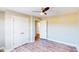 Bedroom with wood laminate floors, ceiling fan, and double door closet at 6715 Princeton Kenly Rd, Princeton, NC 27569