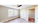 Bright bedroom featuring natural light, wood laminate floors, and double door closet at 6715 Princeton Kenly Rd, Princeton, NC 27569
