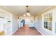 Open dining area with stylish lighting and an adjacent kitchen with white cabinets at 6715 Princeton Kenly Rd, Princeton, NC 27569