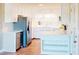 Bright kitchen features stainless steel appliances, white cabinetry, and an island with additional storage at 6715 Princeton Kenly Rd, Princeton, NC 27569